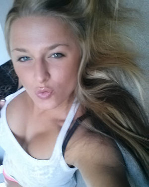 18 year old female Doris G slips off her underwear to pose naked on her bed